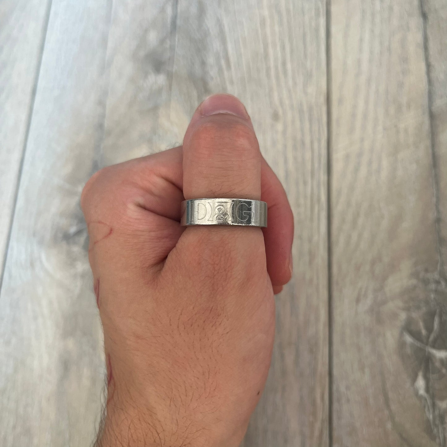 Dolce &amp; Gabbana SS04 SEX Ring is a stainless steel ring from the Spring/Summer 2004 collection. The exterior features an engraved D&amp;G logo on one side and “SEX” engraved on the opposite side. The interior is marked with a small D&amp;G logo. It has a thick band construction and polished finish.