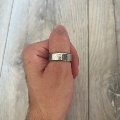 Dolce &amp; Gabbana SS04 SEX Ring is a stainless steel ring from the Spring/Summer 2004 collection. The exterior features an engraved D&amp;G logo on one side and “SEX” engraved on the opposite side. The interior is marked with a small D&amp;G logo. It has a thick band construction and polished finish.