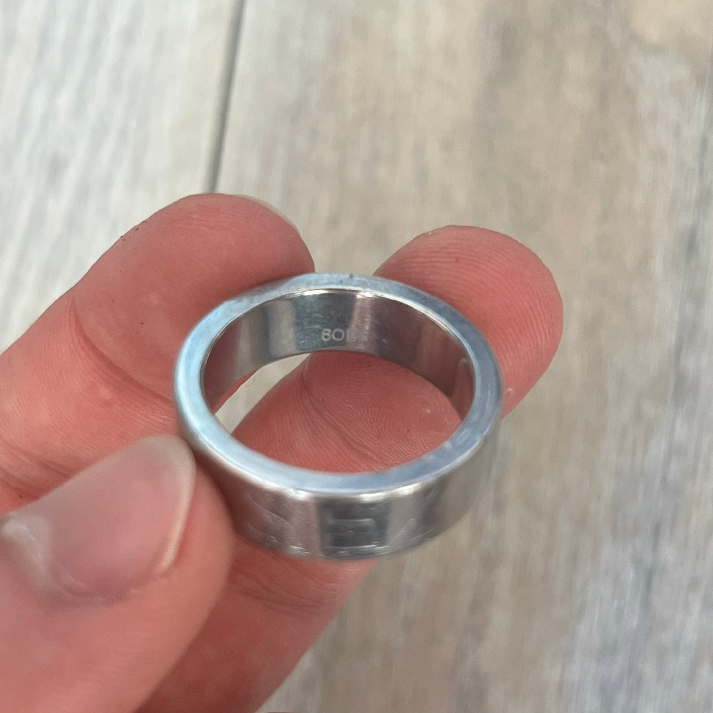 Dolce &amp; Gabbana SS04 SEX Ring is a stainless steel ring from the Spring/Summer 2004 collection. The exterior features an engraved D&amp;G logo on one side and “SEX” engraved on the opposite side. The interior is marked with a small D&amp;G logo. It has a thick band construction and polished finish.
