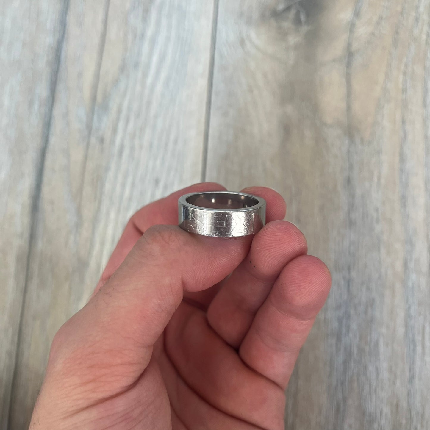Dolce &amp; Gabbana SS04 SEX Ring is a stainless steel ring from the Spring/Summer 2004 collection. The exterior features an engraved D&amp;G logo on one side and “SEX” engraved on the opposite side. The interior is marked with a small D&amp;G logo. It has a thick band construction and polished finish.