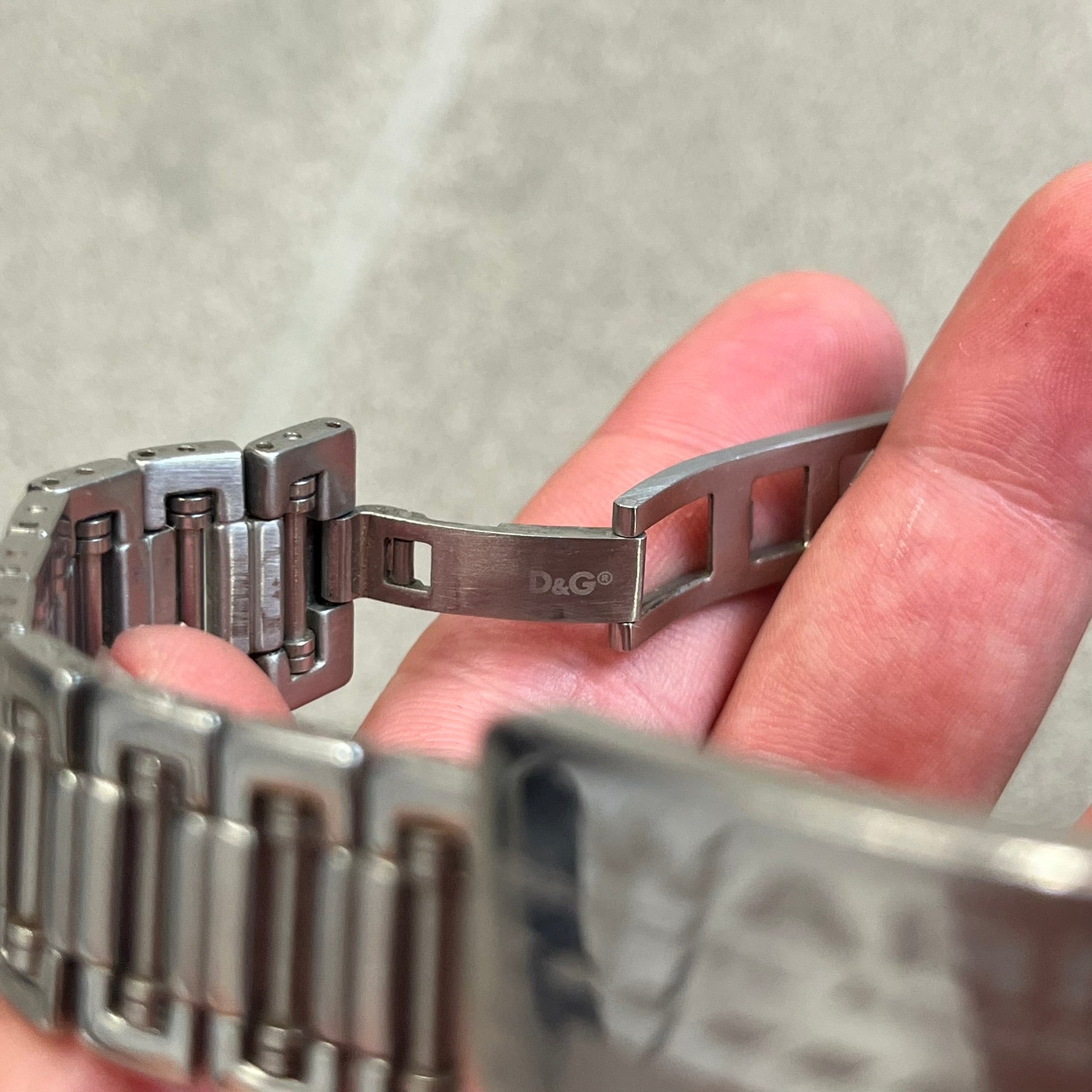 Dolce &amp; Gabbana Warning Stainless Steel Bracelet. From the Spring/Summer 2006 collection, this bracelet features a polished stainless steel design with a clip closure. The front plate displays “Warning Special Access Required” alongside D&amp;G Dolce &amp; Gabbana branding.