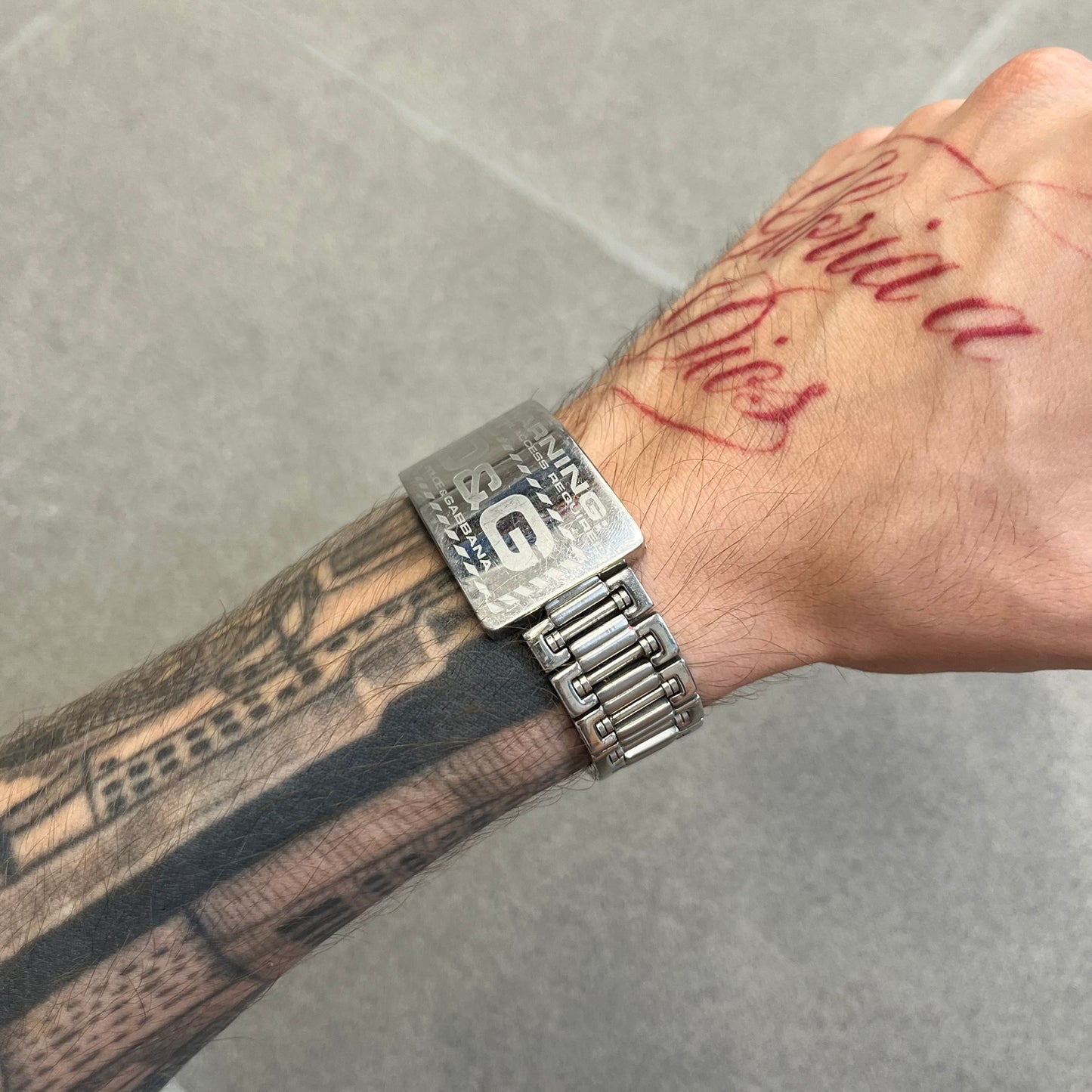 Dolce &amp; Gabbana Warning Stainless Steel Bracelet. From the Spring/Summer 2006 collection, this bracelet features a polished stainless steel design with a clip closure. The front plate displays “Warning Special Access Required” alongside D&amp;G Dolce &amp; Gabbana branding.