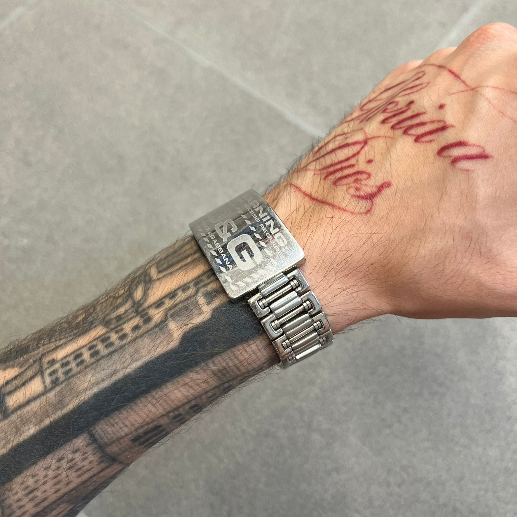 Dolce &amp; Gabbana Warning Stainless Steel Bracelet. From the Spring/Summer 2006 collection, this bracelet features a polished stainless steel design with a clip closure. The front plate displays “Warning Special Access Required” alongside D&amp;G Dolce &amp; Gabbana branding.