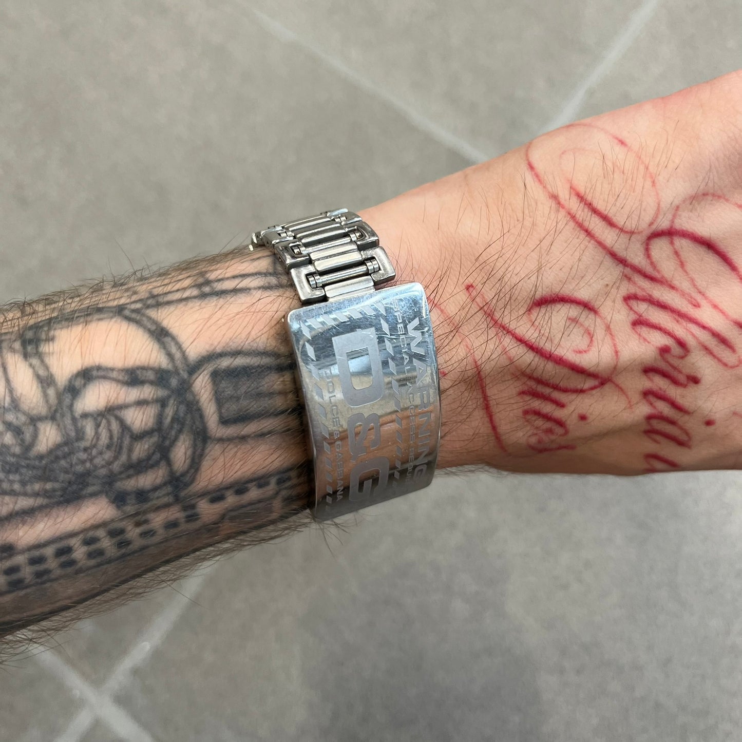 Dolce &amp; Gabbana Warning Stainless Steel Bracelet. From the Spring/Summer 2006 collection, this bracelet features a polished stainless steel design with a clip closure. The front plate displays “Warning Special Access Required” alongside D&amp;G Dolce &amp; Gabbana branding.