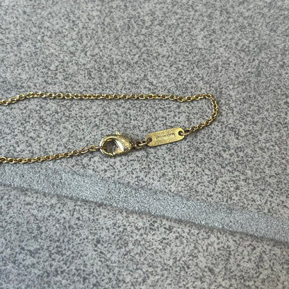 Dolce &amp; Gabbana SS25 Gold Cross Necklace features a gold-tone brass chain with a detailed 3D cross pendant depicting Jesus. A Dolce &amp; Gabbana plaque with “Made in Italy” text is positioned near the clasp. Comes with the original black box and certificate card.