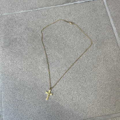 Dolce &amp; Gabbana SS25 Gold Cross Necklace features a gold-tone brass chain with a detailed 3D cross pendant depicting Jesus. A Dolce &amp; Gabbana plaque with “Made in Italy” text is positioned near the clasp. Comes with the original black box and certificate card.
