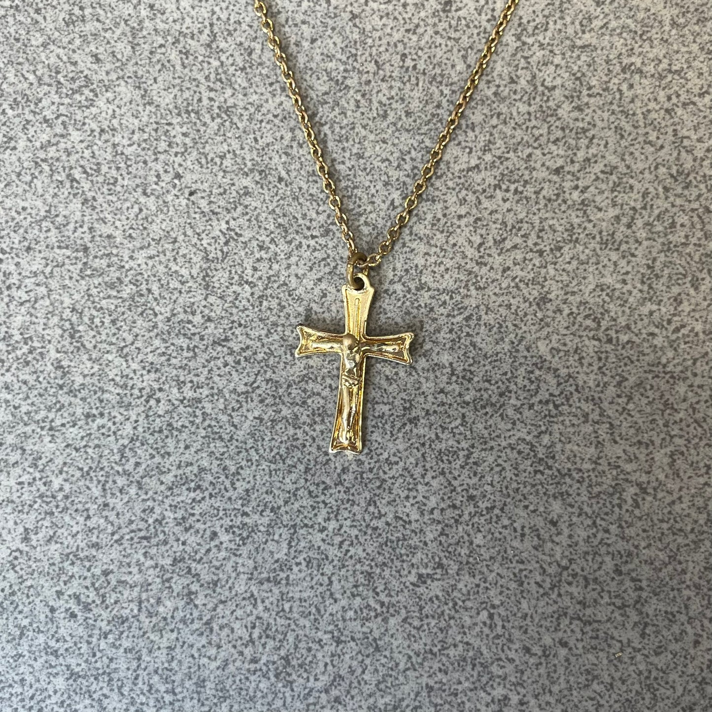 Dolce &amp; Gabbana SS25 Gold Cross Necklace features a gold-tone brass chain with a detailed 3D cross pendant depicting Jesus. A Dolce &amp; Gabbana plaque with “Made in Italy” text is positioned near the clasp. Comes with the original black box and certificate card.