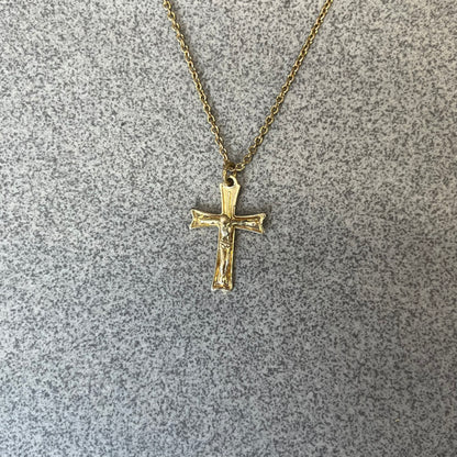 Dolce &amp; Gabbana SS25 Gold Cross Necklace features a gold-tone brass chain with a detailed 3D cross pendant depicting Jesus. A Dolce &amp; Gabbana plaque with “Made in Italy” text is positioned near the clasp. Comes with the original black box and certificate card.