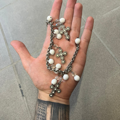 Dolce &amp; Gabbana Silver Charm Cross DJ0253 Bracelet features a silver-tone chain bracelet with white bead charms, three cross-shaped charms made from circular elements, and a D&amp;G logo charm. The bracelet has a silver-tone metal construction.&nbsp;