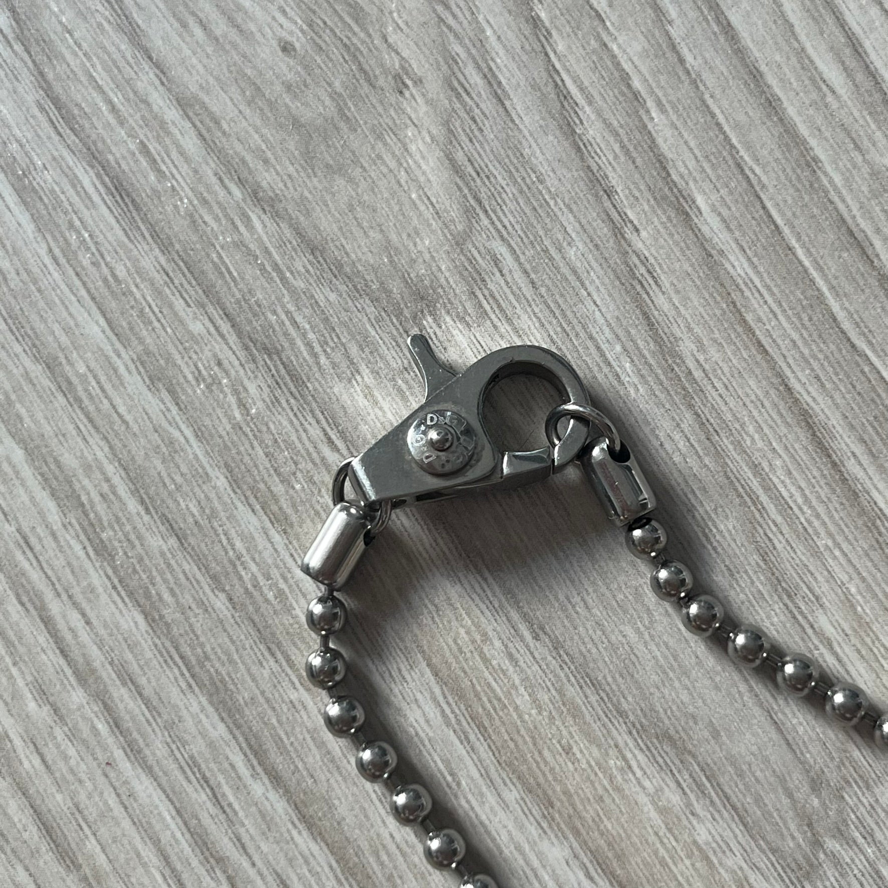 Metal keychain with clasp on a wooden surface