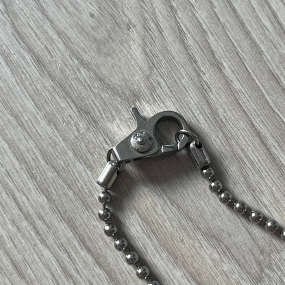 Metal keychain with clasp on a wooden surface
