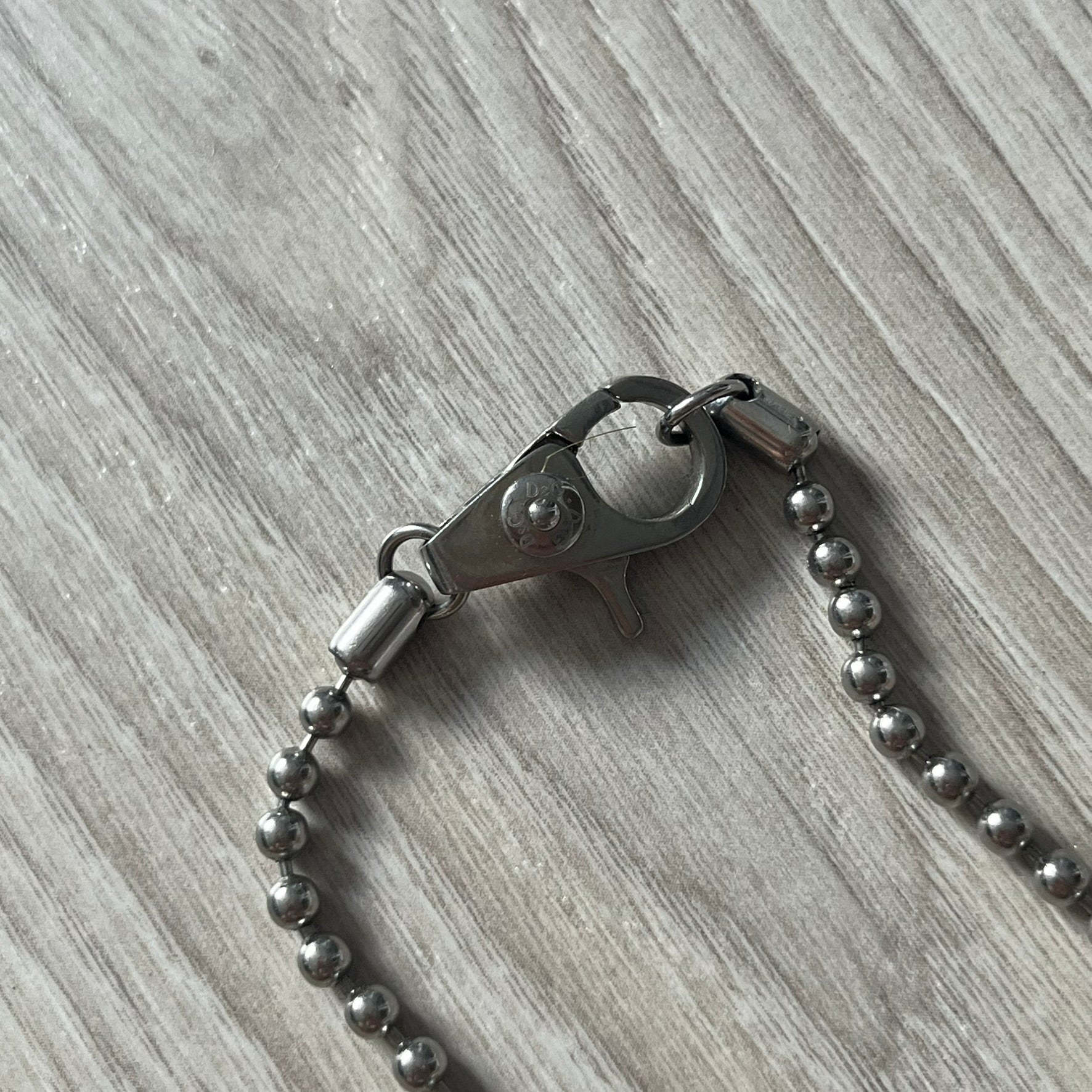 Metal keychain with chain on a wooden surface
