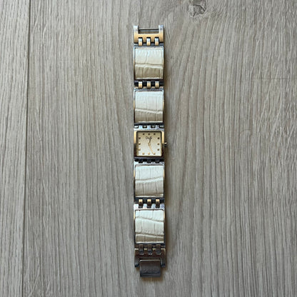 Dolce &amp; Gabbana white analog watch with a silver bracelet featuring white leather-like panels. The case seamlessly aligns with the width of the bracelet for a sleek, integrated look. A refined statement piece blending luxury design with modern elegance.