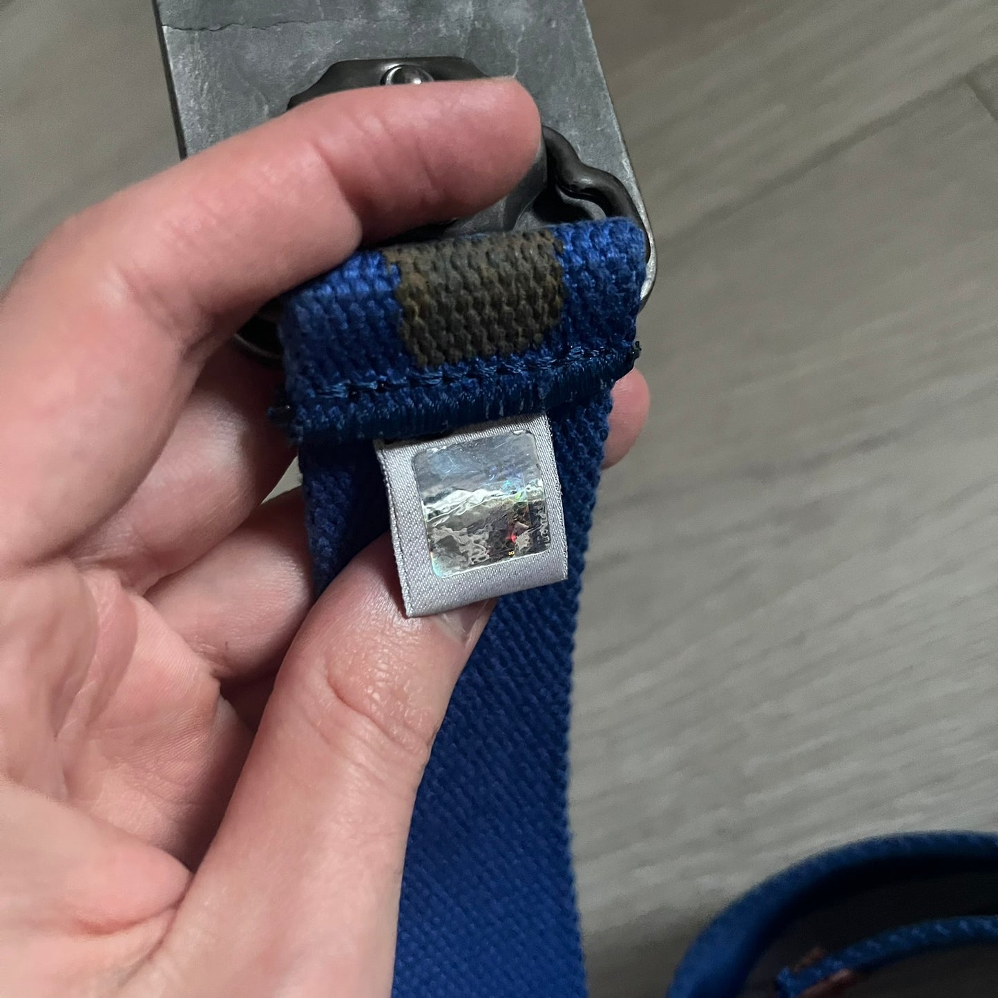 Dolce &amp; Gabbana “High Spirits” Fabric Belt in blue with a brown/gray central stripe and enamel-finished metal buckle. The buckle features vintage iconography and “High Spirits” lettering in vivid orange/red and navy tones. A rare 2000s-era Dolce &amp; Gabbana belt showcasing the brand’s early denim aesthetic.