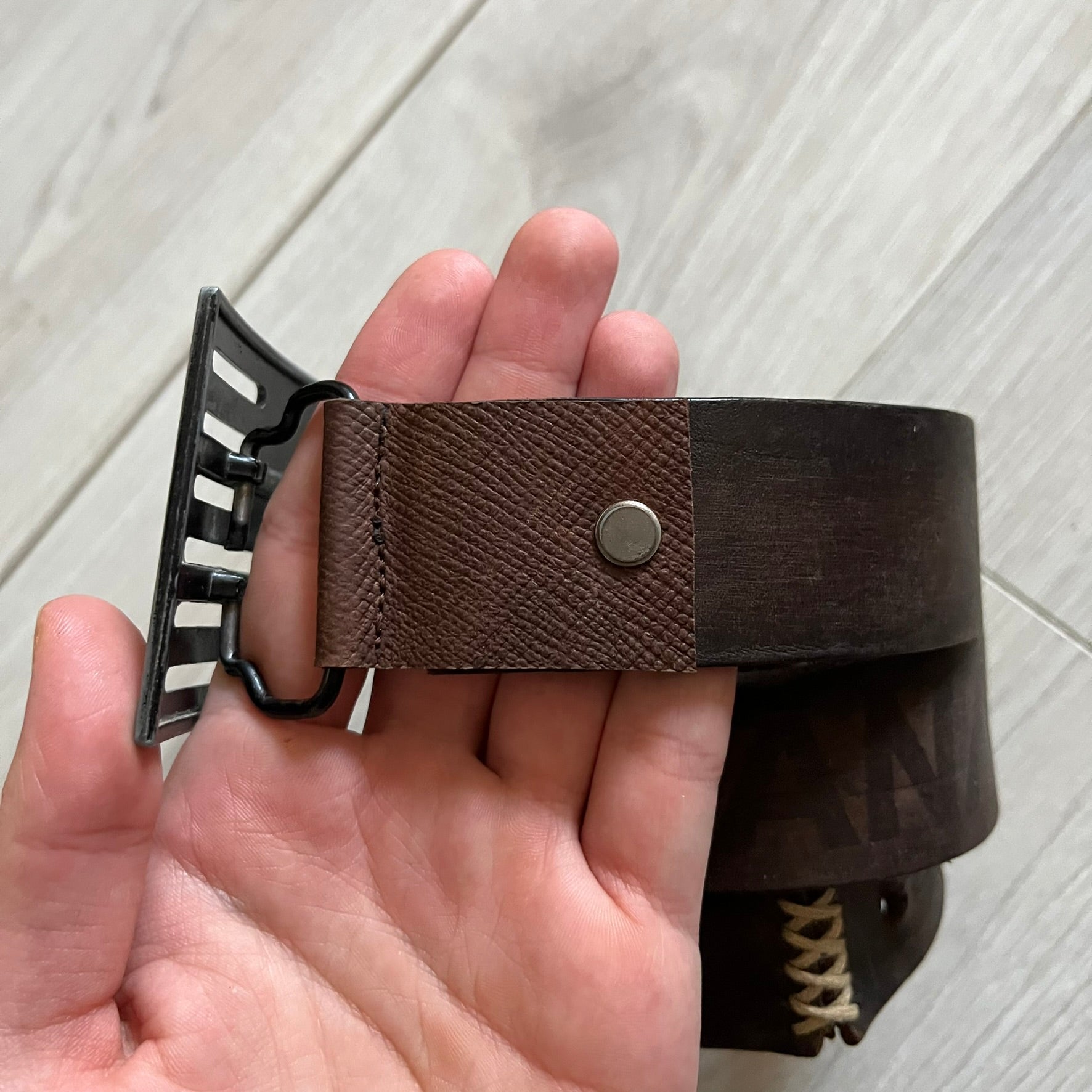 Dolce &amp; Gabbana USA Flag Leather Belt crafted from brown leather with concave, sunken Dolce &amp; Gabbana and D&amp;G text detailing along the strap. The metal buckle is designed in a flag-inspired layout, featuring six horizontal cut-out lines and D&amp;G Dolce &amp; Gabbana text in the upper-left corner in place of traditional stars. The belt shows visible wear consistent with age, giving it a heavily worn, vintage finish.