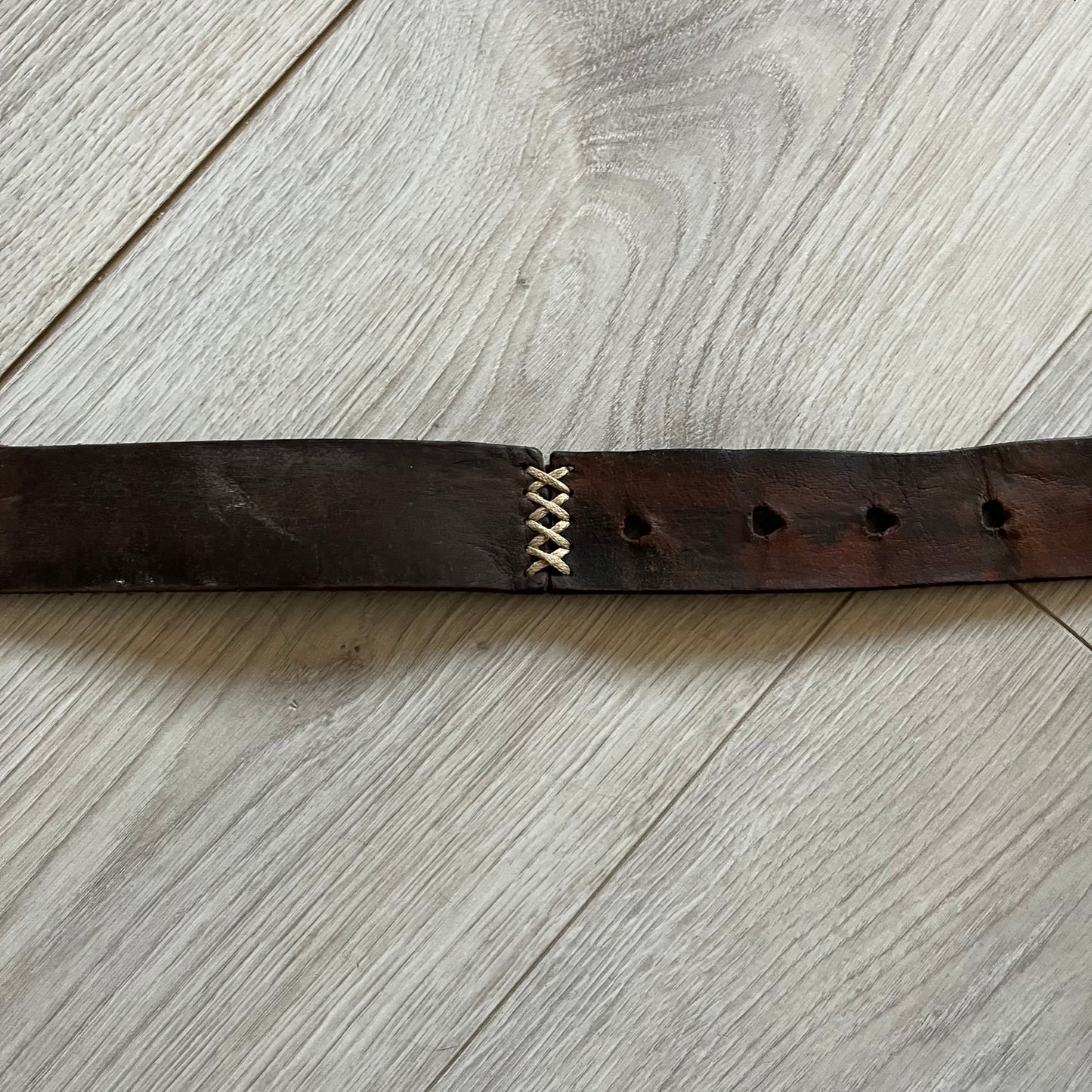 Dolce &amp; Gabbana USA Flag Leather Belt crafted from brown leather with concave, sunken Dolce &amp; Gabbana and D&amp;G text detailing along the strap. The metal buckle is designed in a flag-inspired layout, featuring six horizontal cut-out lines and D&amp;G Dolce &amp; Gabbana text in the upper-left corner in place of traditional stars. The belt shows visible wear consistent with age, giving it a heavily worn, vintage finish.