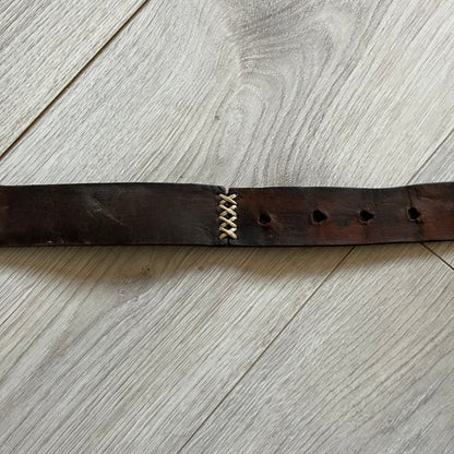 Dolce &amp; Gabbana USA Flag Leather Belt crafted from brown leather with concave, sunken Dolce &amp; Gabbana and D&amp;G text detailing along the strap. The metal buckle is designed in a flag-inspired layout, featuring six horizontal cut-out lines and D&amp;G Dolce &amp; Gabbana text in the upper-left corner in place of traditional stars. The belt shows visible wear consistent with age, giving it a heavily worn, vintage finish.
