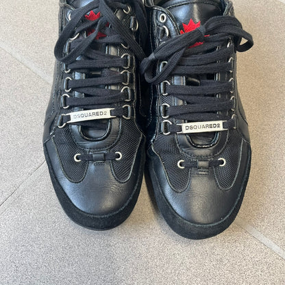 Dsquared2 2010's Multi Fabric Legendary Sneakers are constructed from tonal velvet, patent leather, metal eyelets and a woven rubber sole. They feature a red embroidered Canadian leaf on the tongue, a metal Dsquared2 plaque at the base of the laces, and an embroidered black Dsquared2 logo.