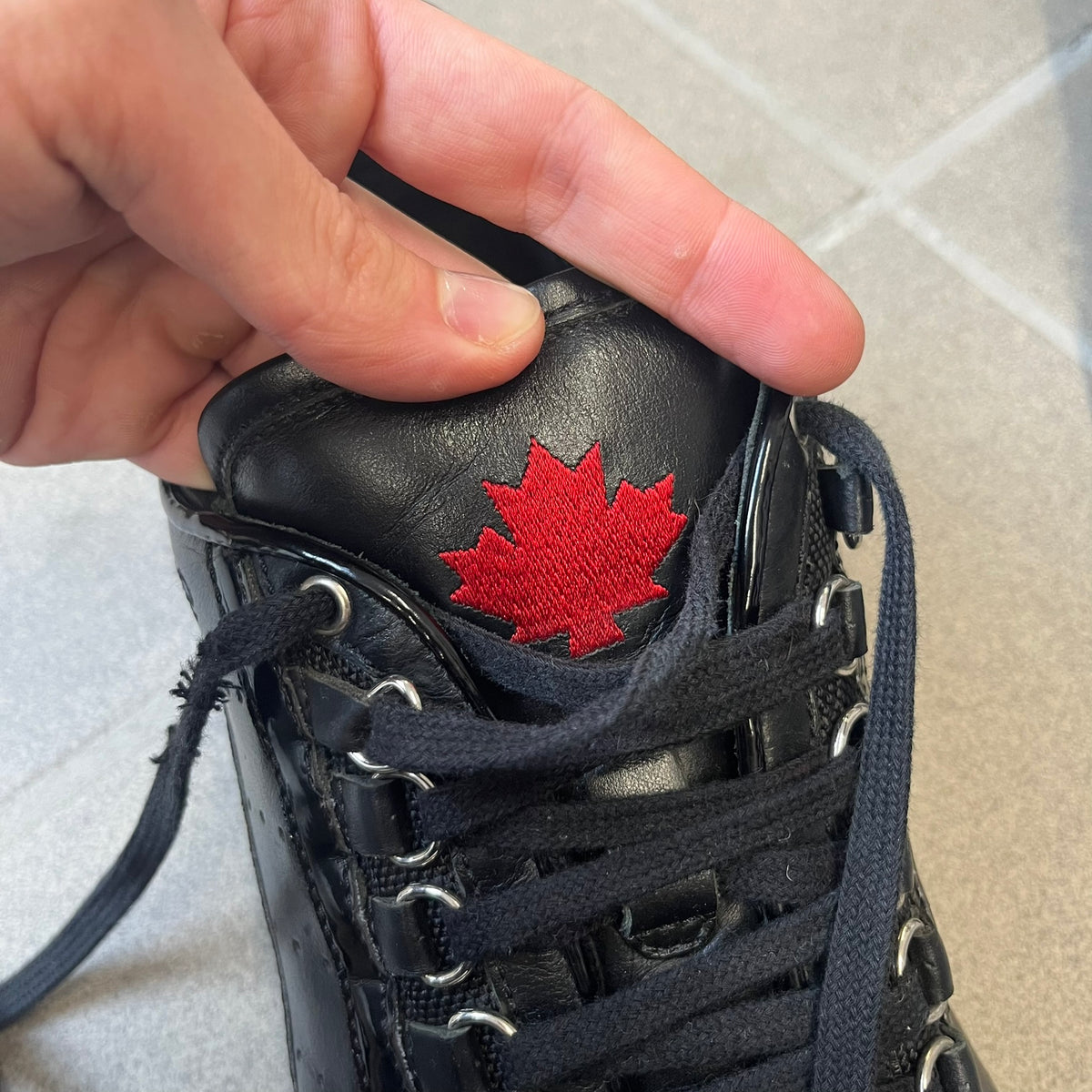 Dsquared2 2010's Multi Fabric Legendary Sneakers are constructed from tonal velvet, patent leather, metal eyelets and a woven rubber sole. They feature a red embroidered Canadian leaf on the tongue, a metal Dsquared2 plaque at the base of the laces, and an embroidered black Dsquared2 logo.