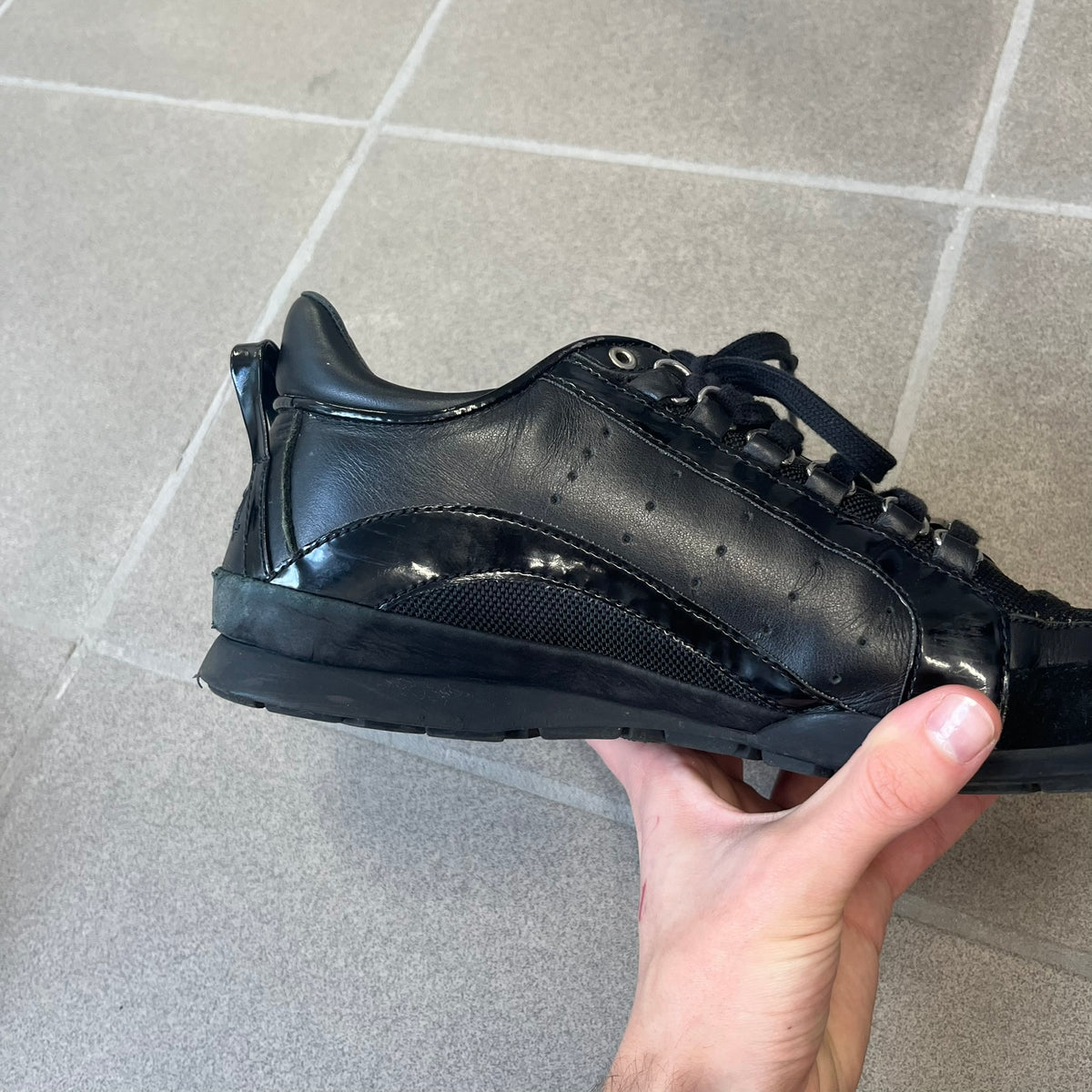 Dsquared2 2010's Multi Fabric Legendary Sneakers are constructed from tonal velvet, patent leather, metal eyelets and a woven rubber sole. They feature a red embroidered Canadian leaf on the tongue, a metal Dsquared2 plaque at the base of the laces, and an embroidered black Dsquared2 logo.