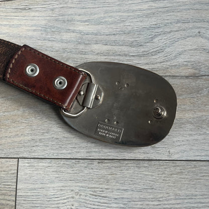 Dsquared2 Big Red Plaque Leather Belt is a leather belt featuring a large oval metal buckle with a silver-tone frame and red metallic center. The buckle displays DSQUARED2 text in the middle, while the strap includes stamped branding and product details. Made from brown leather, the belt is size small.