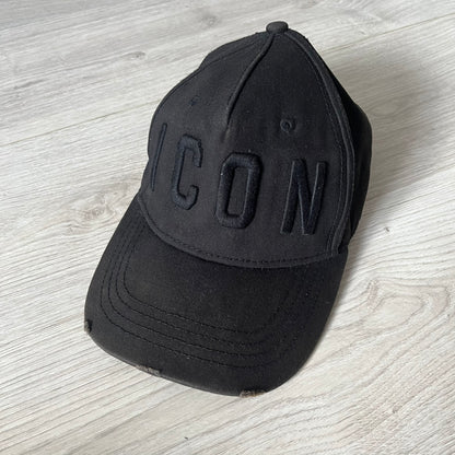 Black cap with 'ICON' text on a light wooden surface