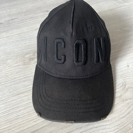 Black cap with 'ICON' text on a light wooden surface