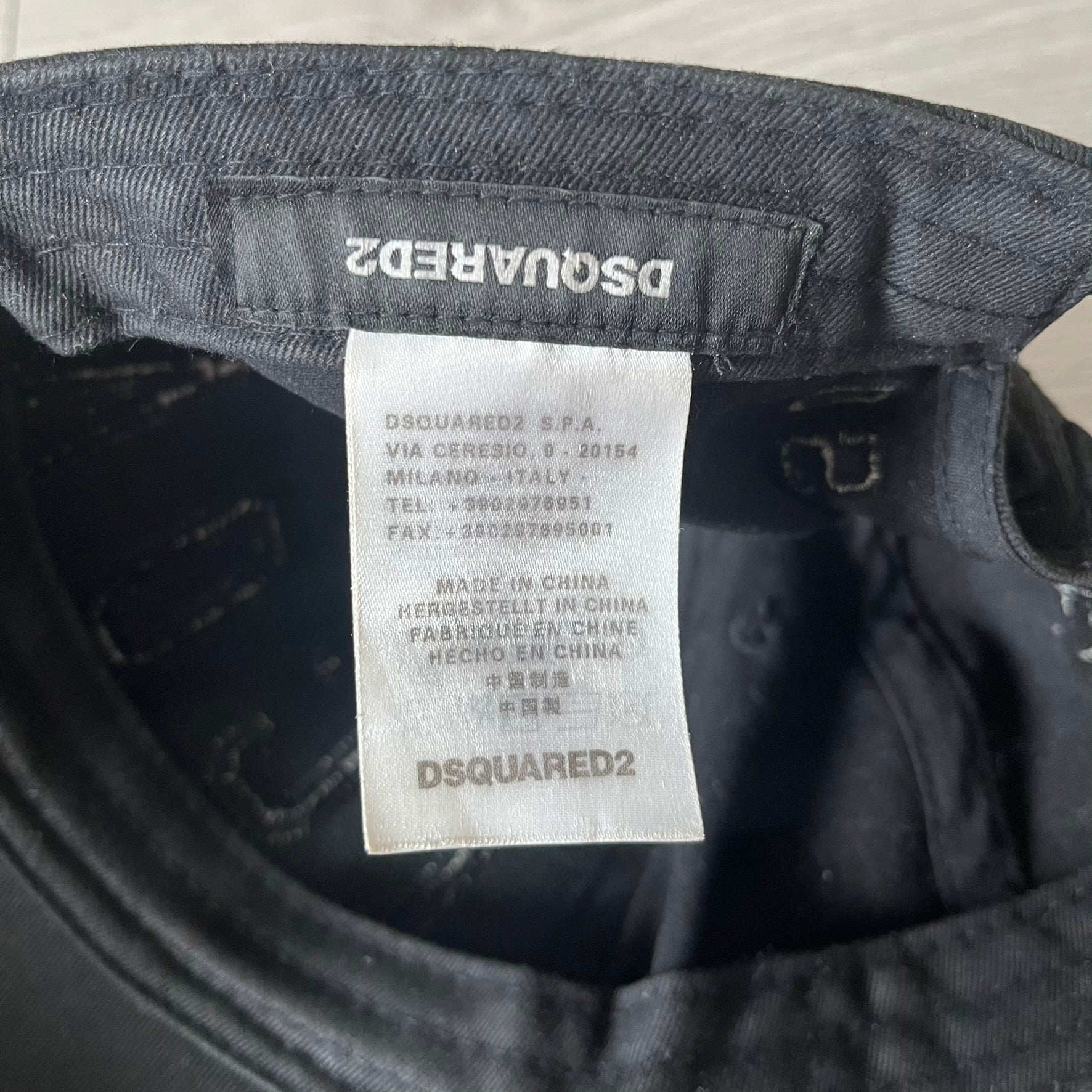 Close-up of a Dsquared2 label on a garment with visible text.