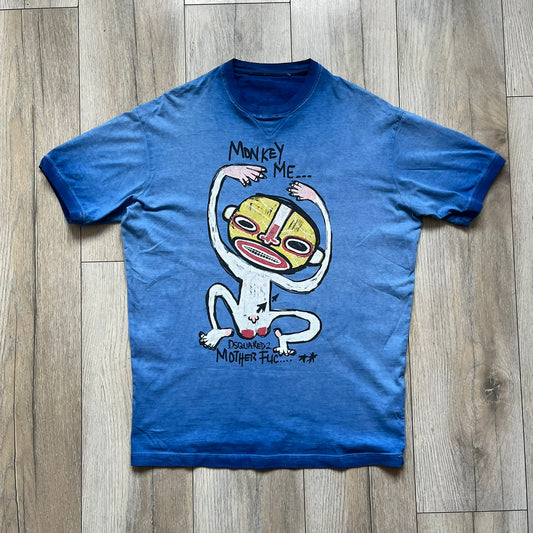 Dsquared2 Blue Rebel Monkey T-Shirt from the Spring/Summer 2015 collection. Crafted in Italy from cotton, the tee features a washed blue finish with darker tonal hems and a lighter faded center. The front displays a large stylized monkey graphic in yellow, white, red, and black, with text reading “Monkey Me… Dsquared2 Motherfuc…” incorporated into the design.