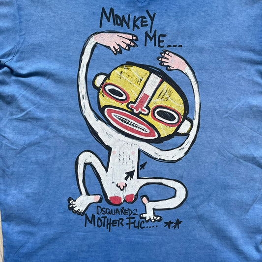 Dsquared2 Blue Rebel Monkey T-Shirt from the Spring/Summer 2015 collection. Crafted in Italy from cotton, the tee features a washed blue finish with darker tonal hems and a lighter faded center. The front displays a large stylized monkey graphic in yellow, white, red, and black, with text reading “Monkey Me… Dsquared2 Motherfuc…” incorporated into the design.
