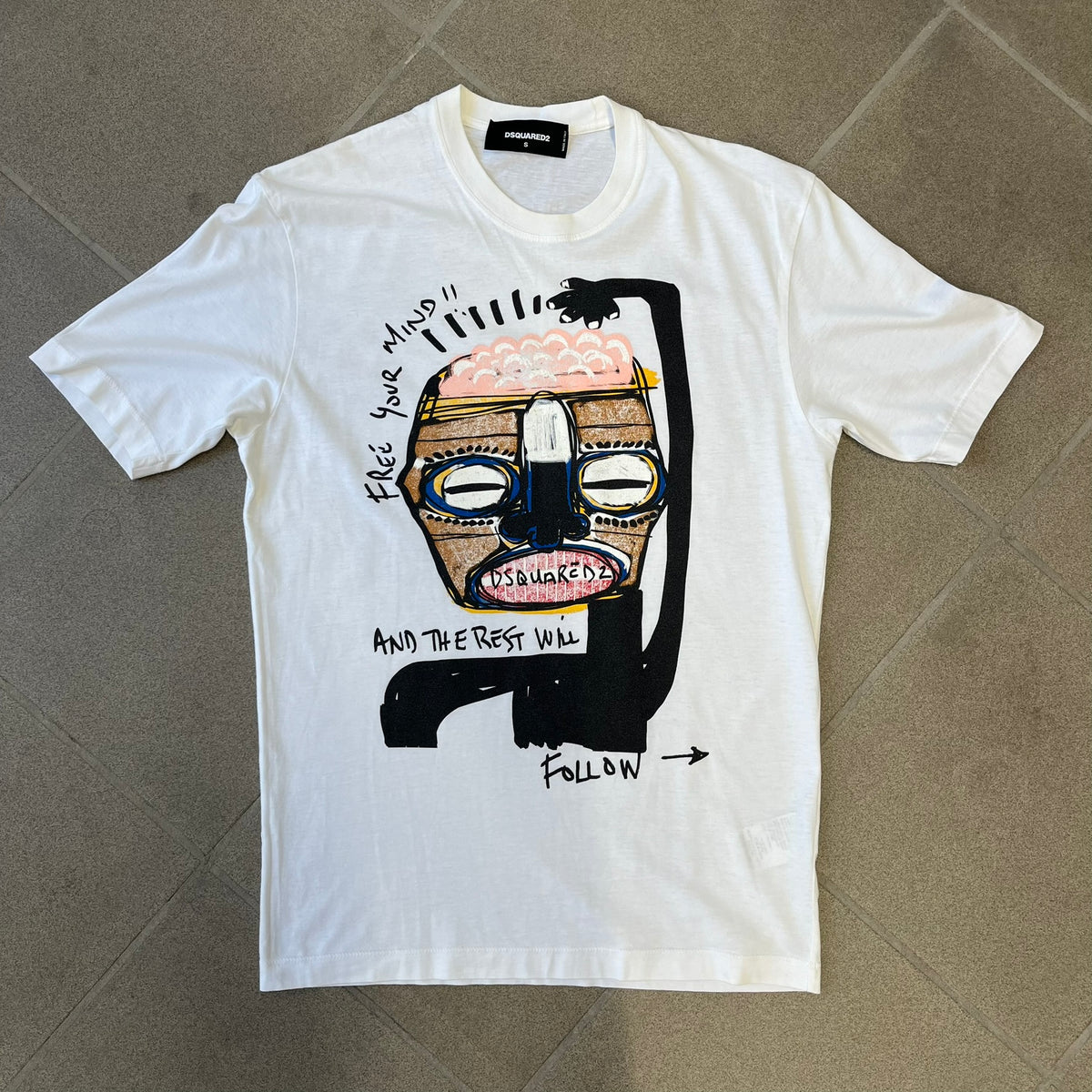 ● Dsquared2 SS2015 “Free Your Mind” T-shirt is a white cotton tee with a front graphic that features a black Basquiat-inspired figure scratching his brain with “Free Your Mind and the Rest Will Follow” text in a contrasting design. The piece is made in Italy and 100% cotton.