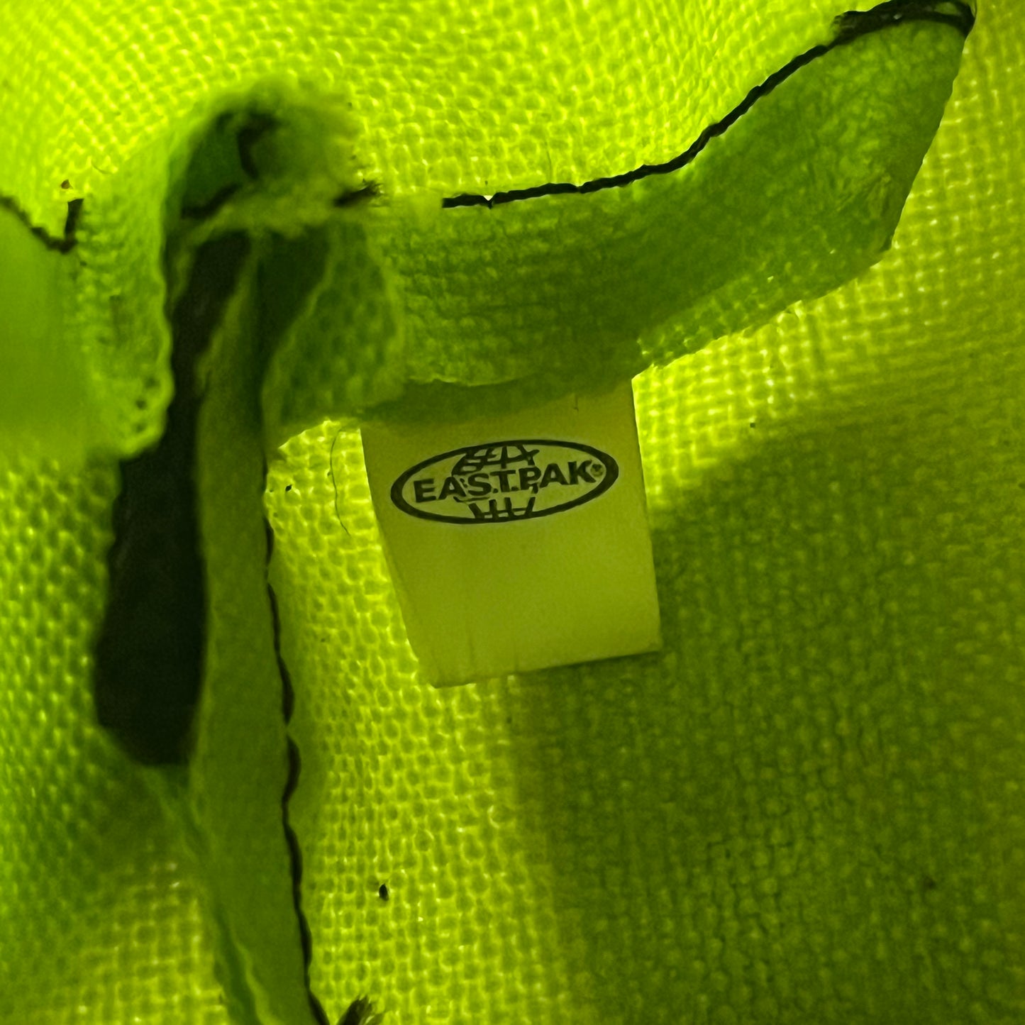 Eastpak’s Mini Green Backpack is a collectible-sized accessory with elastic pack straps. While it can be used as a tiny bag, it’s more often seen as a novelty piece or keychain. A playful twist on the brand’s iconic design.