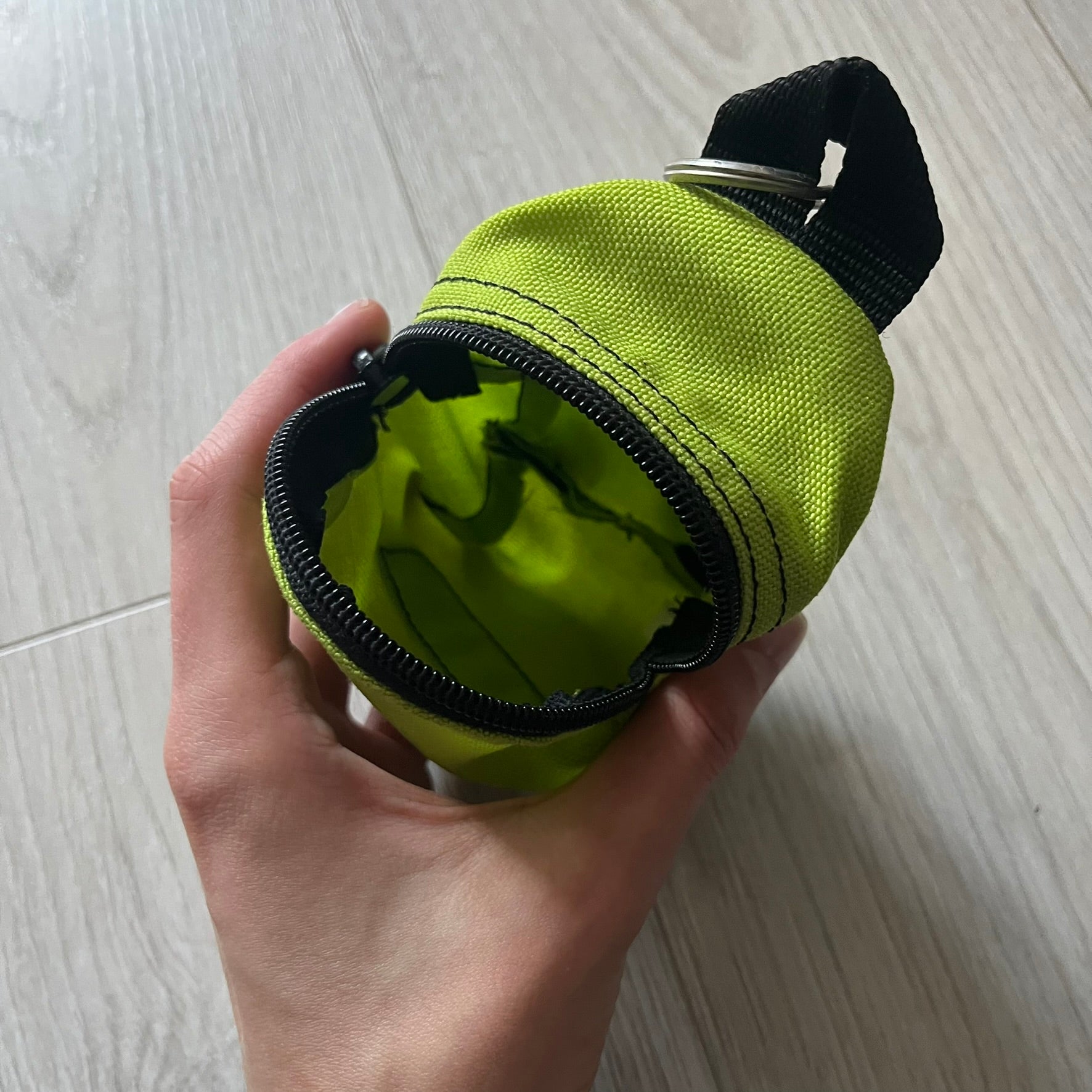 Eastpak’s Mini Green Backpack is a collectible-sized accessory with elastic pack straps. While it can be used as a tiny bag, it’s more often seen as a novelty piece or keychain. A playful twist on the brand’s iconic design.