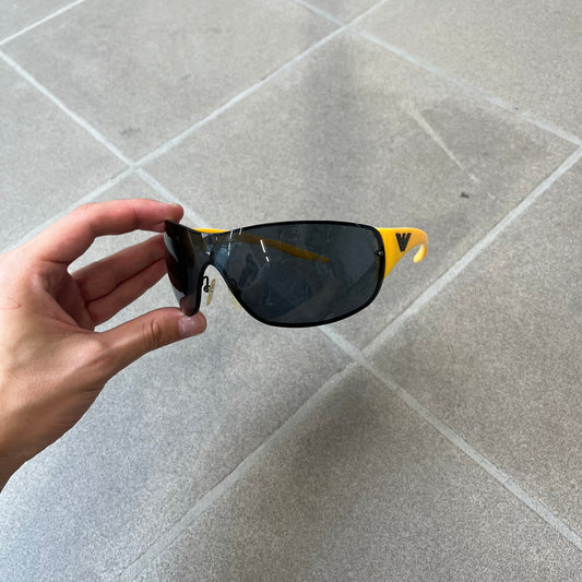 Emporio Armani 2000's Shield Yellow Sunglasses feature a black shield-style front with a single continuous lens and yellow temples. The temples have black Emporio Armani eagle logos, with model EA 9242/S SVG95. Made in Italy and comes with the original red case.

