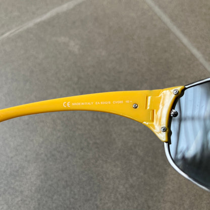 Emporio Armani 2000's Shield Yellow Sunglasses feature a black shield-style front with a single continuous lens and yellow temples. The temples have black Emporio Armani eagle logos, with model EA 9242/S SVG95. Made in Italy and comes with the original red case.
