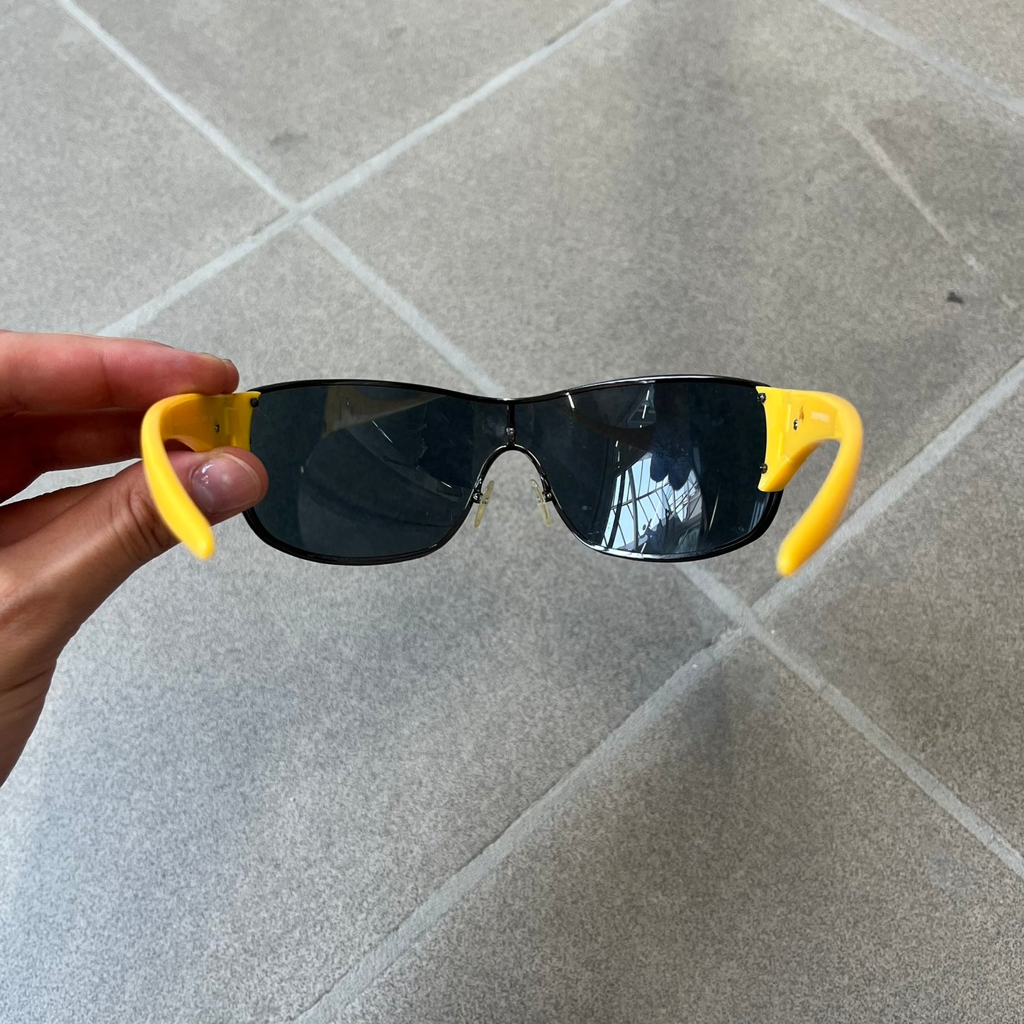 Emporio Armani 2000's Shield Yellow Sunglasses feature a black shield-style front with a single continuous lens and yellow temples. The temples have black Emporio Armani eagle logos, with model EA 9242/S SVG95. Made in Italy and comes with the original red case.
