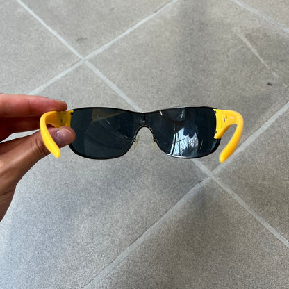 Emporio Armani 2000's Shield Yellow Sunglasses feature a black shield-style front with a single continuous lens and yellow temples. The temples have black Emporio Armani eagle logos, with model EA 9242/S SVG95. Made in Italy and comes with the original red case.
