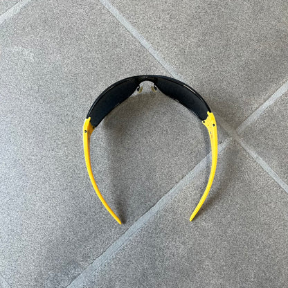 Emporio Armani 2000's Shield Yellow Sunglasses feature a black shield-style front with a single continuous lens and yellow temples. The temples have black Emporio Armani eagle logos, with model EA 9242/S SVG95. Made in Italy and comes with the original red case.
