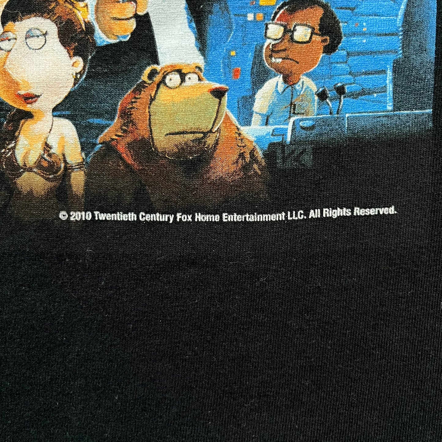 Family Guy Star Wars 2010 “It’s a Trap!” Tee is a black short-sleeve T-shirt made on a Gildan blank. The front features a large graphic in Family Guy’s Star Wars parody style with yellow “It’s a Trap!” text, and small 2010 Century Fox licensing at the bottom. This shirt was released in 2010 as official Family Guy merchandise