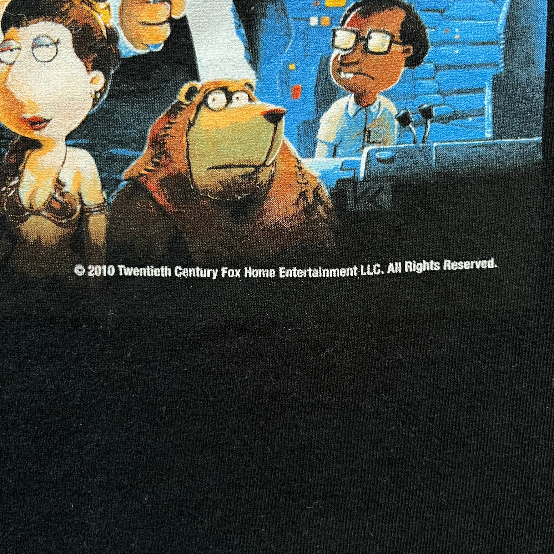 Family Guy Star Wars 2010 “It’s a Trap!” Tee is a black short-sleeve T-shirt made on a Gildan blank. The front features a large graphic in Family Guy’s Star Wars parody style with yellow “It’s a Trap!” text, and small 2010 Century Fox licensing at the bottom. This shirt was released in 2010 as official Family Guy merchandise