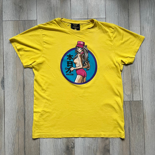 Fishbone Anime Girl 2000’s Yellow Tee is a yellow T-shirt featuring a large blue circle on the front with an anime-style naked girl wearing a pink hat and shorts. Made in the 2000s, it includes a black Fishbone neck tag.