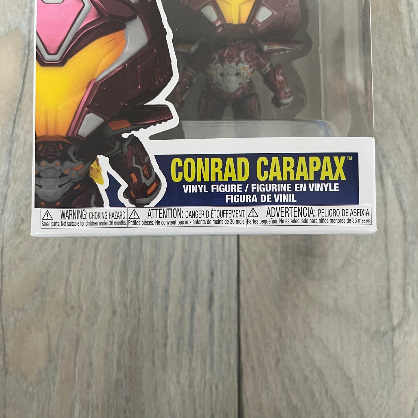 Funko Pop! Movies: Blue Beetle Conrad Carapax #1405 is a 2023 vinyl figure from the DC Blue Beetle (2023) movie line. It depicts Conrad Carapax in his armored design with a color scheme of deep maroon, bright yellow, and metallic accents. The figure is part of the standard 4-inch POP! vinyl series and features detailed sculpting based on the film character