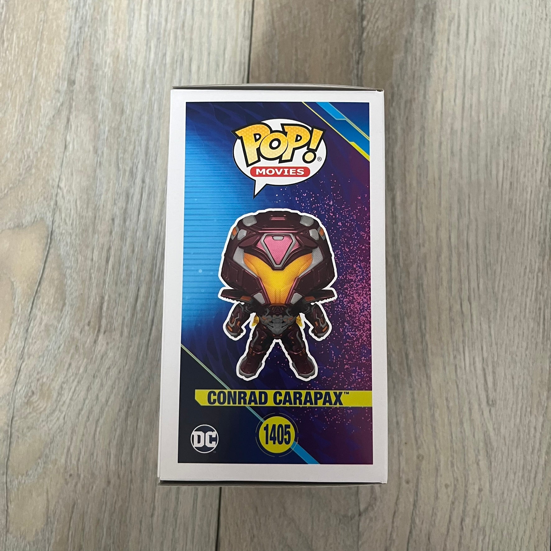 Funko Pop! Movies: Blue Beetle Conrad Carapax #1405 is a 2023 vinyl figure from the DC Blue Beetle (2023) movie line. It depicts Conrad Carapax in his armored design with a color scheme of deep maroon, bright yellow, and metallic accents. The figure is part of the standard 4-inch POP! vinyl series and features detailed sculpting based on the film character