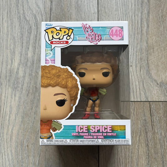Funko Pop! Rocks Ice Spice (Classic Y2K!) #448 Figure is a vinyl collectible released in 2025 as part of the Funko Pop! Rocks music series. The figure represents Ice Spice wearing her orange Y2K! era outfit and holding stacks of money in both hands. The figure follows the standard Funko Pop! stylized design and was released on May 8, 2025 under the Pop! Rocks line.