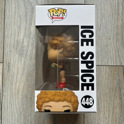 Funko Pop! Rocks Ice Spice (Classic Y2K!) #448 Figure is a vinyl collectible released in 2025 as part of the Funko Pop! Rocks music series. The figure represents Ice Spice wearing her orange Y2K! era outfit and holding stacks of money in both hands. The figure follows the standard Funko Pop! stylized design and was released on May 8, 2025 under the Pop! Rocks line.