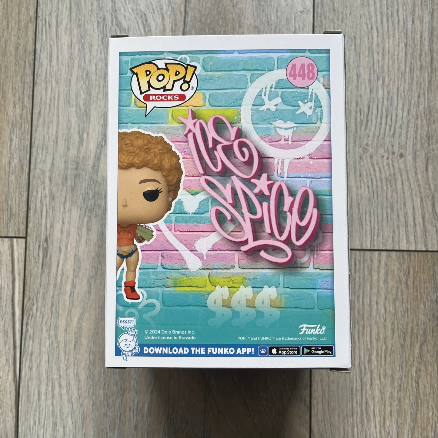 Funko Pop! Rocks Ice Spice (Classic Y2K!) #448 Figure is a vinyl collectible released in 2025 as part of the Funko Pop! Rocks music series. The figure represents Ice Spice wearing her orange Y2K! era outfit and holding stacks of money in both hands. The figure follows the standard Funko Pop! stylized design and was released on May 8, 2025 under the Pop! Rocks line.