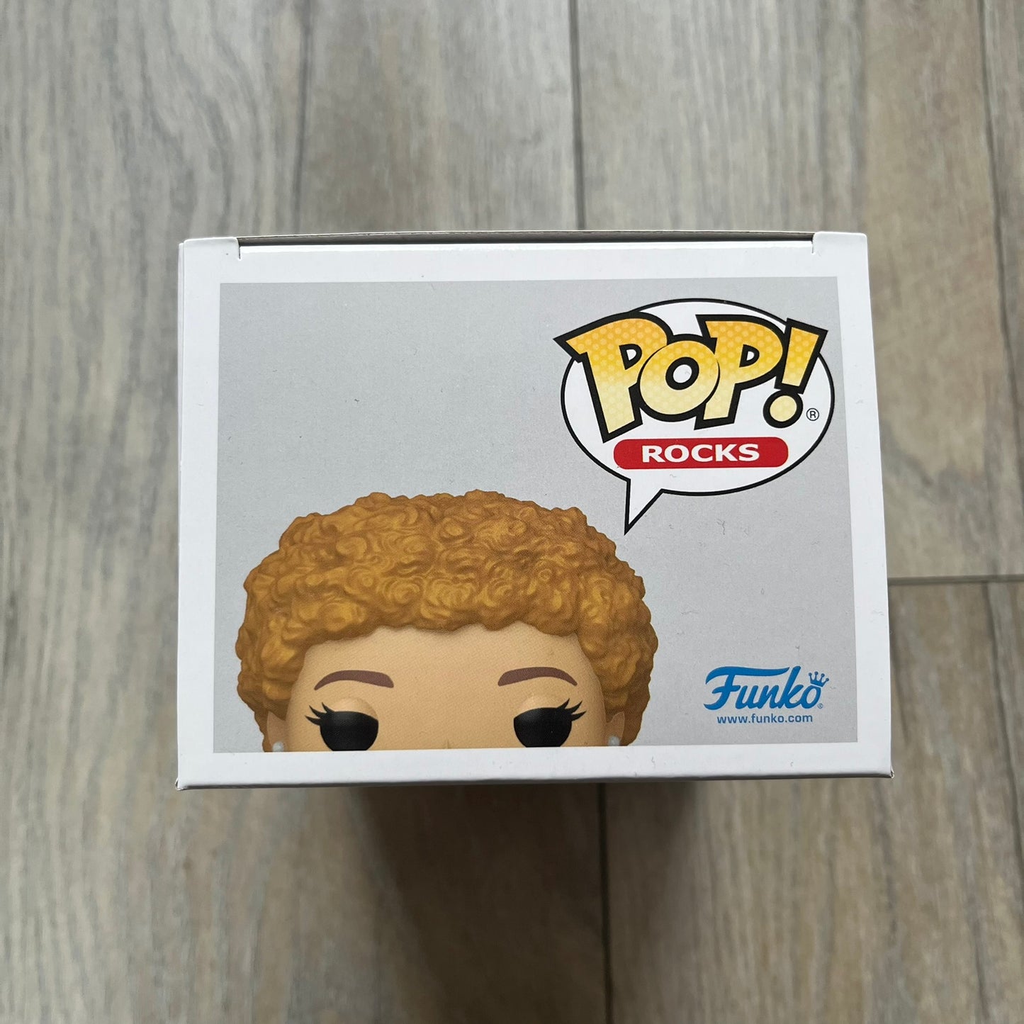 Funko Pop! Rocks Ice Spice (Classic Y2K!) #448 Figure is a vinyl collectible released in 2025 as part of the Funko Pop! Rocks music series. The figure represents Ice Spice wearing her orange Y2K! era outfit and holding stacks of money in both hands. The figure follows the standard Funko Pop! stylized design and was released on May 8, 2025 under the Pop! Rocks line.