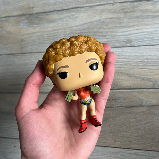 Funko Pop! Rocks Ice Spice (Classic Y2K!) #448 Figure is a vinyl collectible released in 2025 as part of the Funko Pop! Rocks music series. The figure represents Ice Spice wearing her orange Y2K! era outfit and holding stacks of money in both hands. The figure follows the standard Funko Pop! stylized design and was released on May 8, 2025 under the Pop! Rocks line.