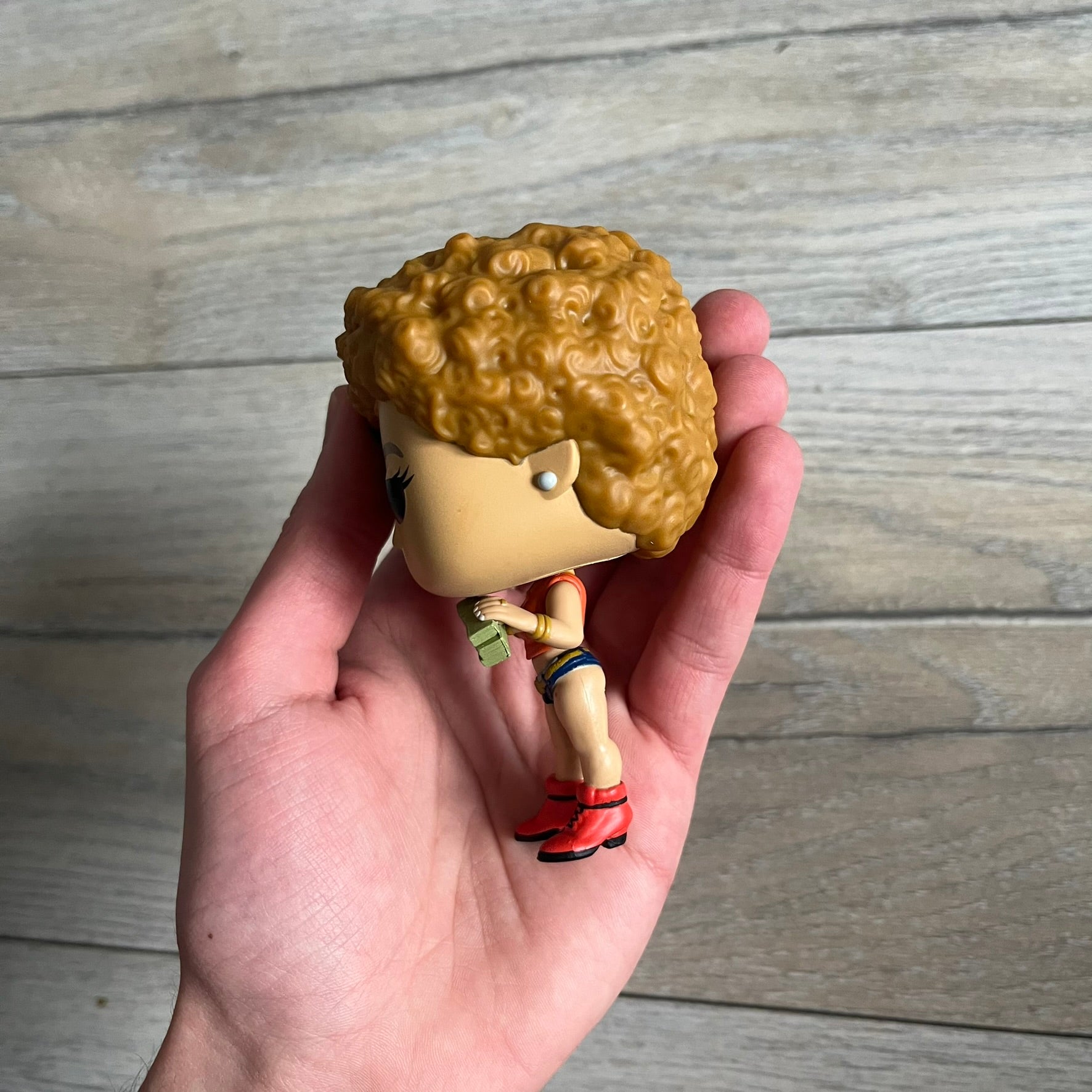 Funko Pop! Rocks Ice Spice (Classic Y2K!) #448 Figure is a vinyl collectible released in 2025 as part of the Funko Pop! Rocks music series. The figure represents Ice Spice wearing her orange Y2K! era outfit and holding stacks of money in both hands. The figure follows the standard Funko Pop! stylized design and was released on May 8, 2025 under the Pop! Rocks line.