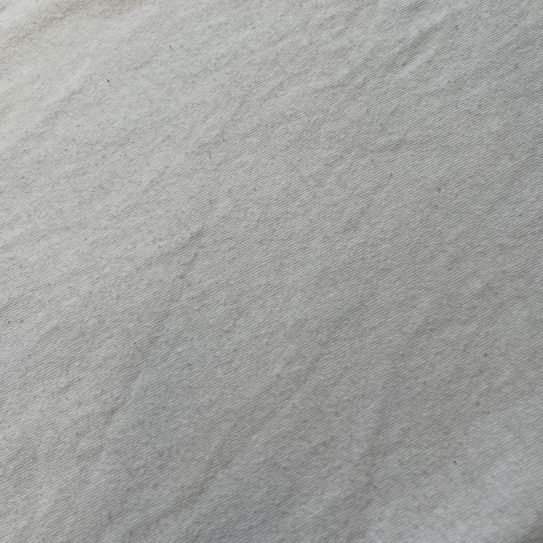 GTA V Los Santos 2013 White Tee features a white design with a large “Los Santos” graphic on the front in a tattoo-style font. The lower front includes a GTA V tag detail, while the neck tag features the Rockstar logo. The back has a small black Rockstar logo.
